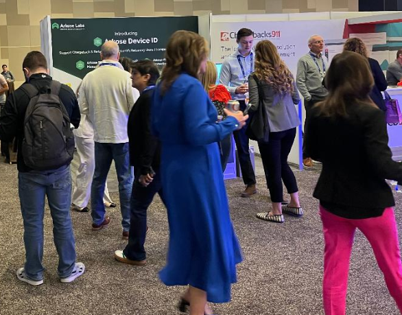 Attendees at MRC Vegas visiting exhibitor booths discuss device intelligence.